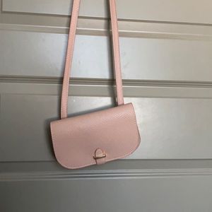 Small pink crossbody bag.
